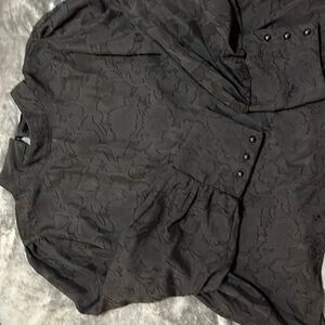 Sheer black blouse long sleeve with buttons on cuffs.